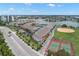 Scenic view of waterfront property featuring a marina, baseball field, and tennis courts at 9201 Captiva Cir, St Pete Beach, FL 33706