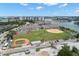 Scenic aerial view of a waterfront property featuring a community park, tennis courts, and marina at 9201 Captiva Cir, St Pete Beach, FL 33706
