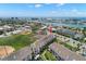Aerial view showcasing the complex with tennis courts and proximity to the water and recreational amenities at 9201 Captiva Cir, St Pete Beach, FL 33706
