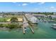 Aerial view of a waterfront property featuring a private dock and boat lift at 9201 Captiva Cir, St Pete Beach, FL 33706