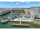 Stunning aerial view of waterfront community featuring boat docks, swimming pool, and beautiful landscaping at 9201 Captiva Cir, St Pete Beach, FL 33706