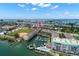 Stunning aerial view showcasing waterfront condos, a marina, community pool, and nearby baseball field with waterfront access at 9201 Captiva Cir, St Pete Beach, FL 33706