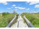 Boardwalk access to the pristine beach, surrounded by lush dunes and native vegetation at 9201 Captiva Cir, St Pete Beach, FL 33706