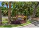 Welcoming community sign amidst lush greenery, showcasing the desirable McKenney Park neighborhood at 9201 Captiva Cir, St Pete Beach, FL 33706