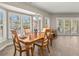 The dining room features bay windows, tile floors, and a chandelier at 9201 Captiva Cir, St Pete Beach, FL 33706