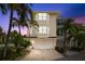 Exterior view of this lovely townhome, showcasing the two-car garage and well-maintained landscaping at 9201 Captiva Cir, St Pete Beach, FL 33706