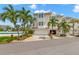 Attractive townhome with a two-car garage, tropical landscaping, and a bright, welcoming facade at 9201 Captiva Cir, St Pete Beach, FL 33706