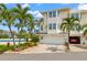 Charming townhome with a two-car garage, lush landscaping, and a welcoming entryway at 9201 Captiva Cir, St Pete Beach, FL 33706