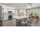 Bright kitchen with white cabinetry, stainless appliances, and a breakfast bar with seating at 9201 Captiva Cir, St Pete Beach, FL 33706