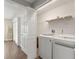 Laundry room with white washer and dryer and a white bi-fold door separating the area at 9201 Captiva Cir, St Pete Beach, FL 33706