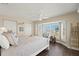Bright main bedroom with a ceiling fan and large windows, allowing for lots of natural light at 9201 Captiva Cir, St Pete Beach, FL 33706