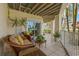 Charming patio features comfortable seating, sliding glass doors, and a spiral staircase, perfect for indoor-outdoor living at 9201 Captiva Cir, St Pete Beach, FL 33706
