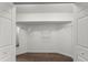 Walk-in closet with wood flooring, white walls, and a built-in wire shelving system at 9201 Captiva Cir, St Pete Beach, FL 33706