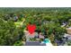 Aerial view of a beautiful property with a swimming pool surrounded by lush greenery at 925 Monticello N Blvd, St Petersburg, FL 33703