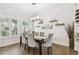 Bright dining room with natural light, modern chandelier, and hardwood floors at 925 Monticello N Blvd, St Petersburg, FL 33703