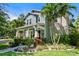 Charming two-story home featuring inviting front porch, lush landscaping, and beautiful curb appeal at 925 Monticello N Blvd, St Petersburg, FL 33703