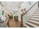 Spacious foyer with wood floors, staircase, and stylish decor, leading into the living space at 925 Monticello N Blvd, St Petersburg, FL 33703