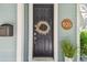 Charming front door adorned with a wreath, complemented by a well-lit porch at 925 Monticello N Blvd, St Petersburg, FL 33703