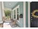 Cozy front porch featuring comfortable seating, mailbox, and natural light at 925 Monticello N Blvd, St Petersburg, FL 33703