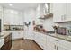 Bright kitchen featuring white cabinets, granite countertops, and stainless steel appliances at 925 Monticello N Blvd, St Petersburg, FL 33703