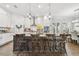Bright kitchen featuring a large island with seating, pendant lighting, and white cabinets at 925 Monticello N Blvd, St Petersburg, FL 33703