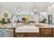 Kitchen island featuring granite countertops, sink, and pendant lights that opens to the living room at 925 Monticello N Blvd, St Petersburg, FL 33703