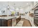 Kitchen with a large island, a stainless steel dishwasher, and stylish pendant lights at 925 Monticello N Blvd, St Petersburg, FL 33703