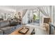Cozy living room with access to outdoor patio through sliding glass doors with decorative curtains at 925 Monticello N Blvd, St Petersburg, FL 33703
