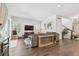 Spacious living room features dark wood floors, large sectional sofa, and a decorative world map on the wall at 925 Monticello N Blvd, St Petersburg, FL 33703