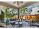 Covered patio with outdoor seating overlooking the fenced backyard and tropical landscaping at 925 Monticello N Blvd, St Petersburg, FL 33703