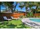 Relaxing pool with a stone border is surrounded by lush landscaping, providing a backyard oasis at 925 Monticello N Blvd, St Petersburg, FL 33703