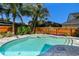 Beautiful backyard pool with sun shelf and surrounded by lush tropical landscaping at 925 Monticello N Blvd, St Petersburg, FL 33703