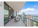 Spacious balcony features comfortable seating, glass railings, and stunning views of the city and ocean at 100 1St N Ave # 2703, St Petersburg, FL 33701