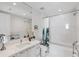 Bright bathroom featuring marble tile, sleek vanity with mirror, and tub-shower combo with decorative shower curtain at 100 1St N Ave # 2703, St Petersburg, FL 33701