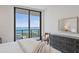 Bright bedroom with floor-to-ceiling windows boasting beautiful water views, stylish furniture, and an area rug at 100 1St N Ave # 2703, St Petersburg, FL 33701