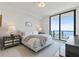 Bright bedroom with floor-to-ceiling windows boasting beautiful water views and stylish bedside tables at 100 1St N Ave # 2703, St Petersburg, FL 33701