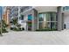 Modern building entrance with lush landscaping, clear signage, and clean architectural lines at 100 1St N Ave # 2703, St Petersburg, FL 33701