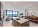 Open-concept living area with modern kitchen, dining table, and ocean views at 100 1St N Ave # 2703, St Petersburg, FL 33701