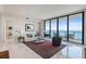 Bright living room with floor-to-ceiling windows boasting beautiful water views, stylish furniture, and a decorative rug at 100 1St N Ave # 2703, St Petersburg, FL 33701