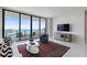 Bright living room with floor-to-ceiling windows boasting beautiful water views, stylish furniture, and a decorative rug at 100 1St N Ave # 2703, St Petersburg, FL 33701