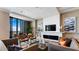 Contemporary living room showcasing stylish furniture, fireplace and expansive windows with city views at 100 1St N Ave # 2703, St Petersburg, FL 33701