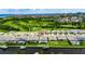 Aerial view shows the property with a screened-in pool, complemented by lush landscaping and a private canal at 1028 Signet Dr, Apollo Beach, FL 33572