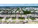 Aerial view of the community and waterway, this house has a three-car garage, paved driveway, and impeccable landscaping at 1028 Signet Dr, Apollo Beach, FL 33572