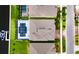 Overhead view shows a home with a screened pool enclosure, landscaping, and a boat dock along a waterway at 1028 Signet Dr, Apollo Beach, FL 33572