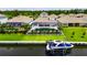 Waterfront view of houses with backyard pools, boat docks, and lush greenery, offering a luxurious lifestyle at 1028 Signet Dr, Apollo Beach, FL 33572