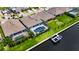 Aerial showing a home with private dock, a screened pool area, and manicured lawn overlooking the waterway at 1028 Signet Dr, Apollo Beach, FL 33572