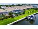 Aerial showcasing a waterfront property featuring screened pool, lush landscaping, and convenient boat dock access at 1028 Signet Dr, Apollo Beach, FL 33572