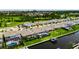 An aerial image features a backyard pool and canal, enhanced by a boat lift, and landscaped surroundings at 1028 Signet Dr, Apollo Beach, FL 33572