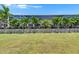 Beautiful screened-in backyard features lush landscaping and well-manicured lawn at 1028 Signet Dr, Apollo Beach, FL 33572