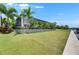 Wide backyard with green grass leading to a screened-in outdoor living space at 1028 Signet Dr, Apollo Beach, FL 33572